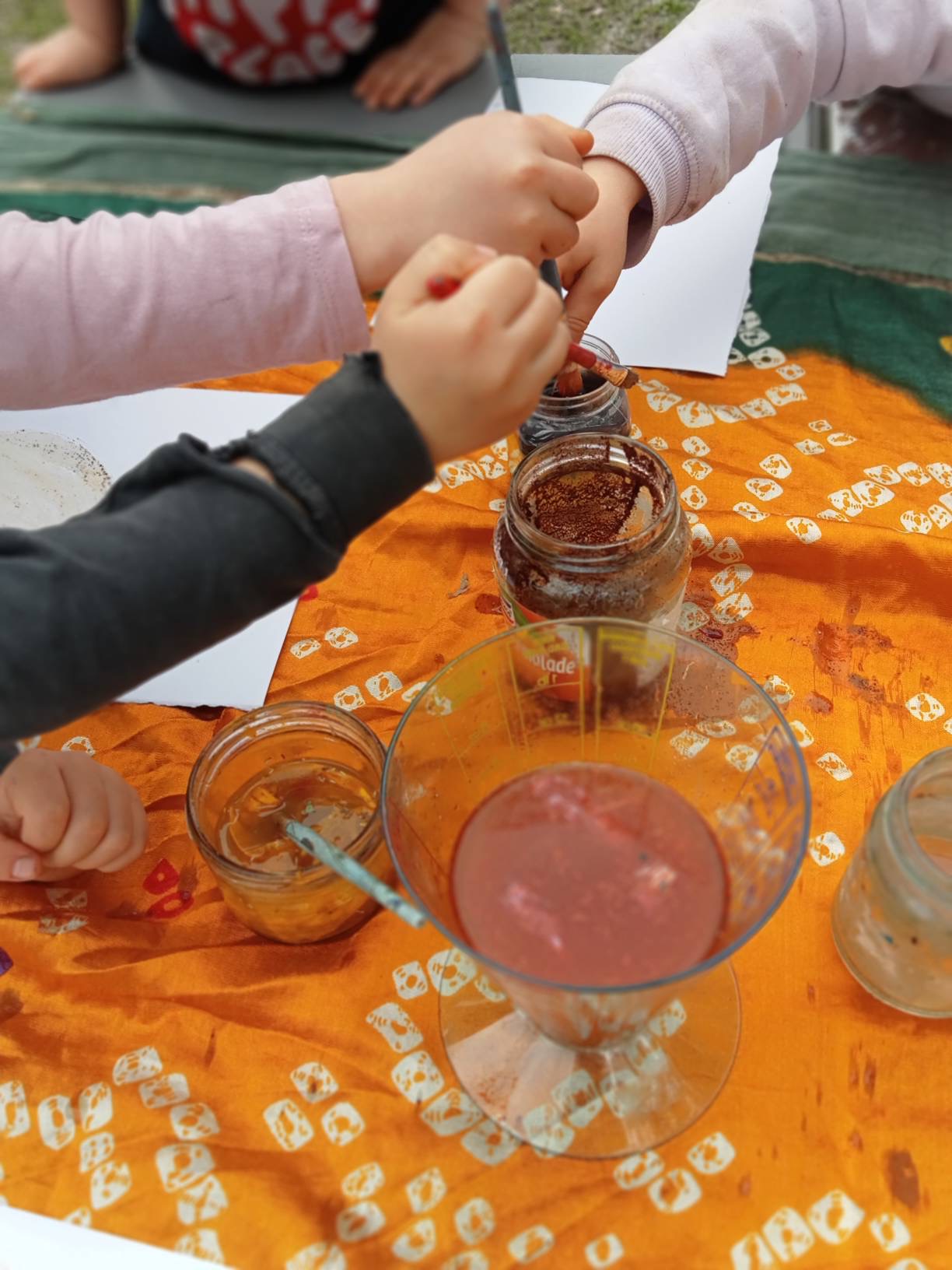 Children making natural pigments and inks outdoors